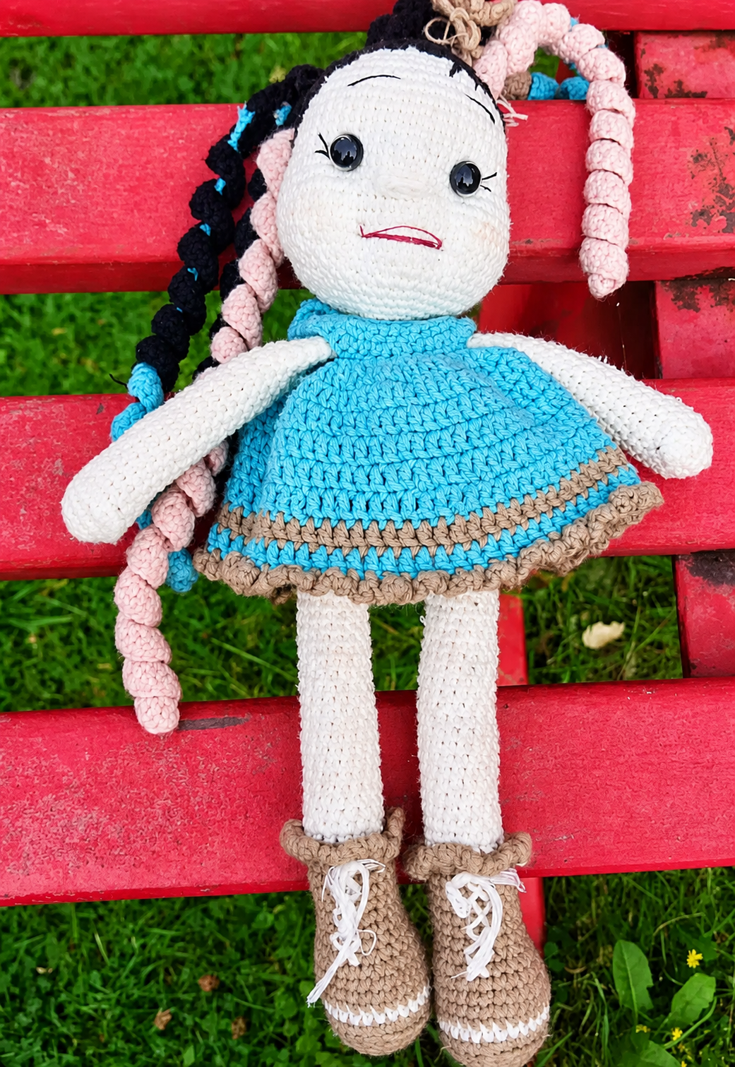Handmade crochet doll photographed outdoors