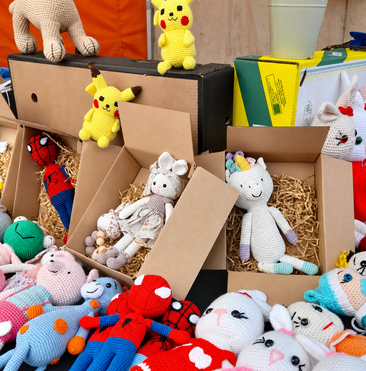 Handmade crochet toys arranged in gift boxes
